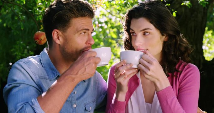 Romantic couple having tea in park