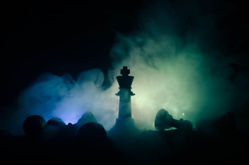 chess board game concept of business ideas and competition and strategy ideas concep. Chess figures on a dark background with smoke and fog