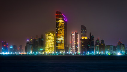 Panorama of modern skyscrapers in Abu Dhabi, United Emirates at night.
