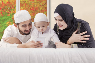 Happy family watching video with autumn