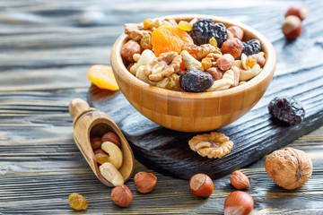 Nuts and dried fruit in a wooden bowl.