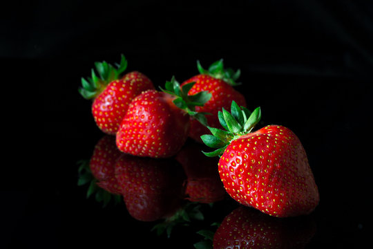 Group of strawberries with reflection