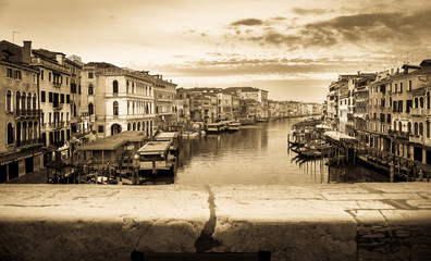 Vintage and panoramic view on famous Grand Canal among historic houses in Venice, Italy at sunrise. Picture took from the Rialto bridge.