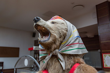 Dummy of a large brown bear in national clothes
