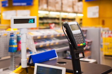Cash desk with payment terminal in supermarket