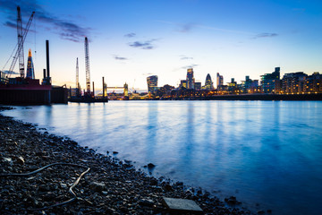 Fototapeta premium London skyline at dusk including Tower Bridge and skyscrapers at financial district. Picture took along the riverside.