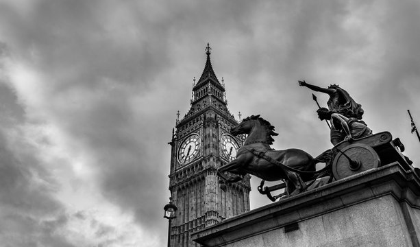 Big Ben and statue of Boadicea and Her Daughters in Westminster London. Black and white picture with dramatic sky.