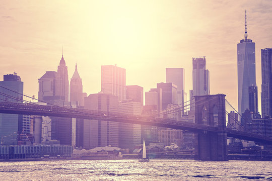 Vintage toned sunset over Manhattan and Brooklyn Bridge, New York City, USA.