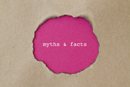 Myths And Facts Word Written Under Torn Paper.