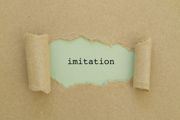 imitation word written under torn paper.