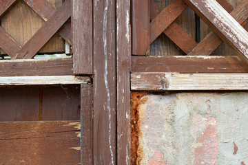 Old brown wood door with parts of wall