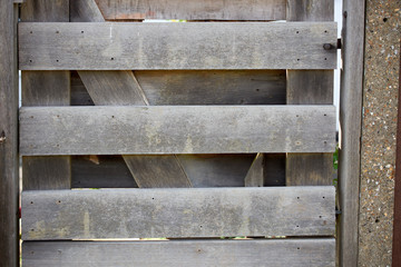 Old brown wood door with parts of wall