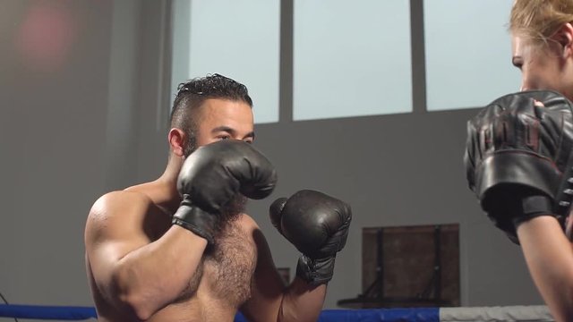 Kickboxing sparring between a man and a woman. Slow motion