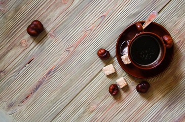 Brown cup of coffee on a wooden table