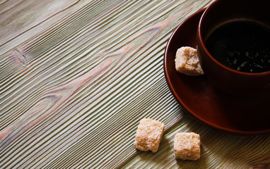 Brown cup of coffee on a wooden table