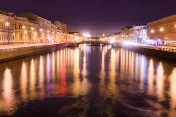 Fototapeta na wymiar View of Lomonosov bridge across the Fontanka river, Saint-Petersburg, at night anover side
