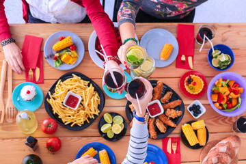 People with drinks while sitting at the dining table, flat lay