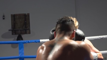 Boxing sparring in the ring between a man and a woman. Training in martial arts