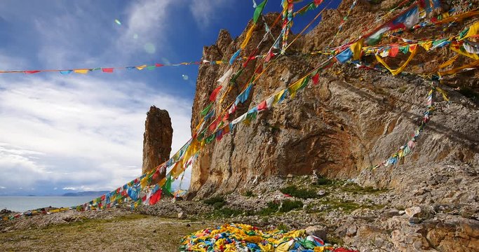 4k Prayer flags at the lake namtso in tibet,ancient holy monk meditation in cave,tibet mansarovar,Danggula(Tanggula) Mountains in xizang Plateau,roof of the World.