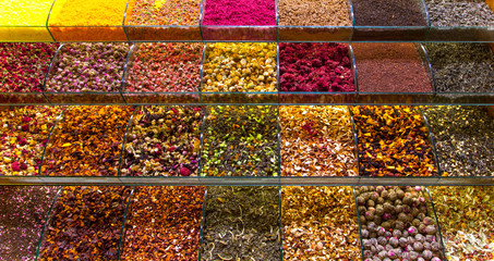 Multicolored spices, teas and nuts on the counter in the market
