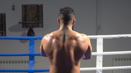 Muscular back professional boxer. Portrait of an athlete in the ring. slow motion