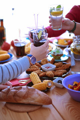 People with drinks while sitting at the dining table