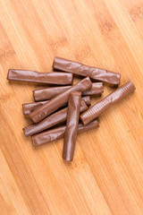 Chewy chocolate logs on a wood background