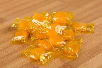 Butterscotch hard candies on a wood background