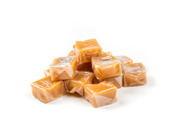 Chewy caramel cubes isolated on a white background