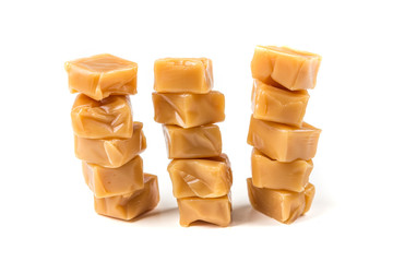 Chewy caramel cubes isolated on a white background