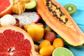 Juicy exotic fruits on blue wooden background
