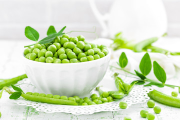 Green peas with leaves on white background