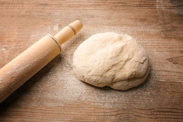 Fototapeta na wymiar Fresh dough on wooden background