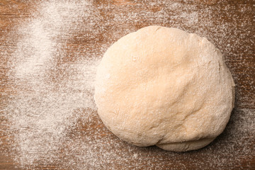 Fresh dough  on wooden background