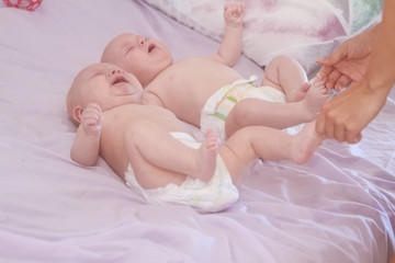 indoor portrait of two young baby twins at home