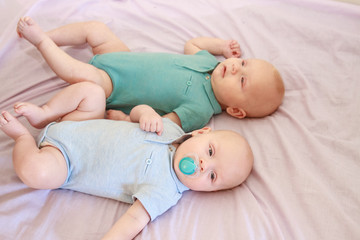 indoor portrait of two young baby twins at home