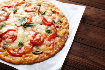Tasty pizza on wooden table