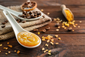 Spoon with orange scrub and sea salt on wooden table