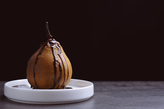 Baked pear on black background