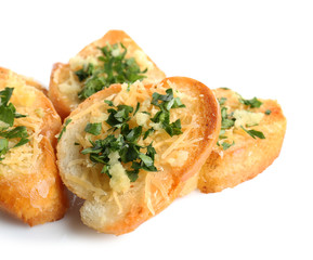 Tasty bread slices with grated cheese, garlic and herbs on white background
