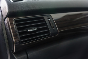 Car air conditioning system grid panel on console. Auto interior detail.