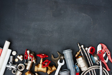 Top view of the plumbing equipment on a black background - obrazy, fototapety, plakaty