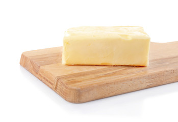 Wooden board with butter on white background, closeup