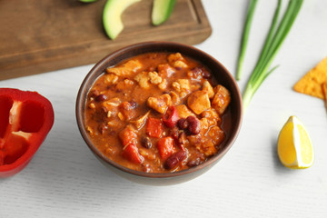 Delicious chili turkey with vegetables on table
