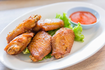 buffalo chicken wings serve with ketchup on a white dish, Selective focus