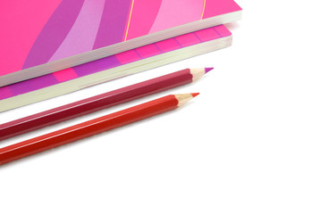 Two pencils and two books are on white background