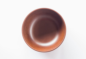top view of brown bowl on white background