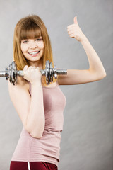 Woman working out at home with dumbbell