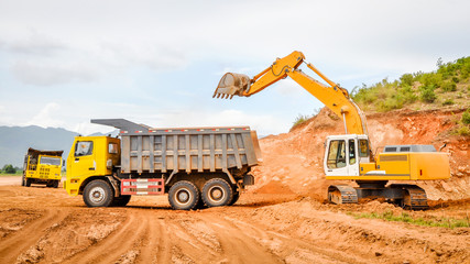 excavator and truck in the road construction job, countryside of Myanmar