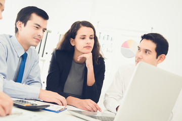 Business people discussing work with laptop computer at the meeting